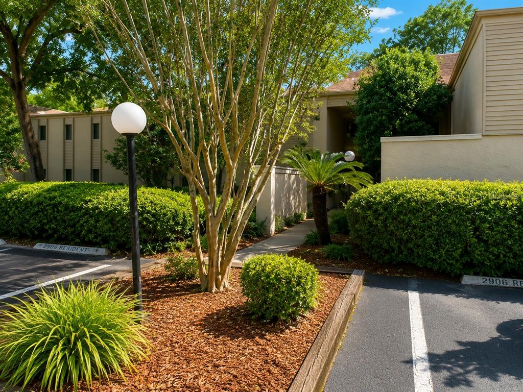 An exterior view of a multi-story apartment building with a landscaped parking area — 3236 S SEMORAN BOULEVARD UNIT 15, ORLANDO, FL