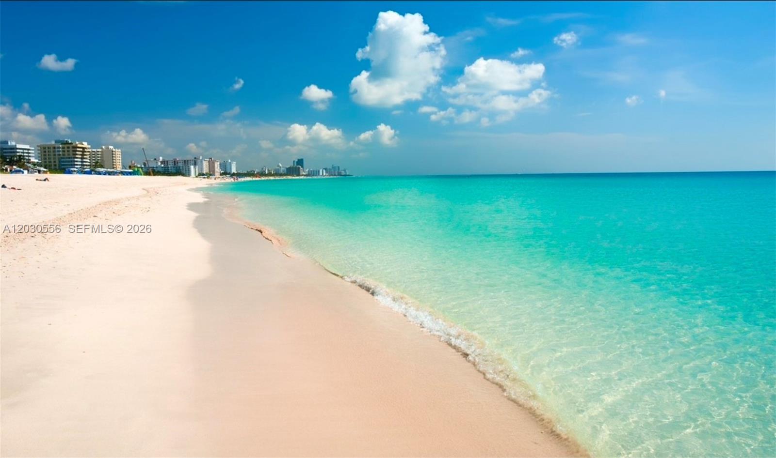 A view of a sandy beach meeting turquoise ocean water under a blue sky — 711 Lenox Ave, Miami Beach FL 33139, MIAMI BEACH, FL