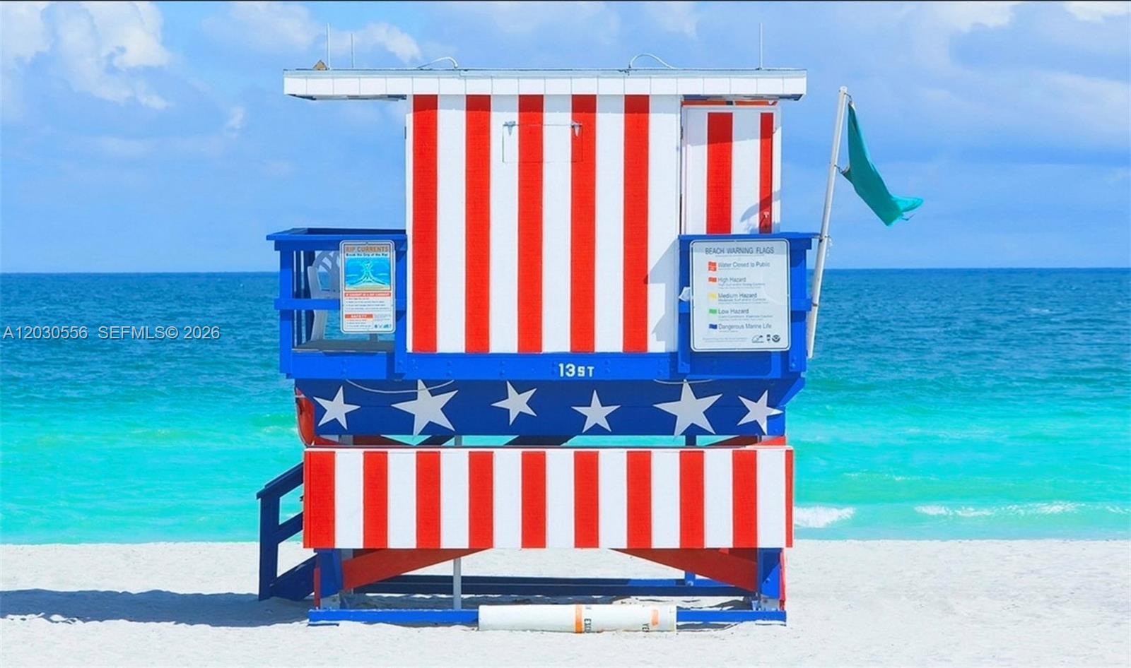 A red, white, and blue lifeguard tower stands on a sandy beach by the ocean — 711 Lenox Ave, Miami Beach FL 33139, MIAMI BEACH, FL