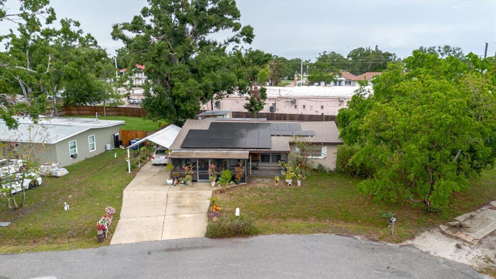 An aerial view of a single-story house with solar panels and a carport — 4015 ASBURY PLACE, SARASOTA, FL