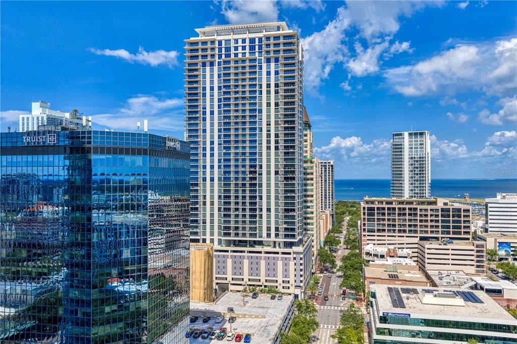 An aerial view of a city skyline featuring a tall residential tower and surrounding buildings — 275 1ST AVENUE S UNIT 3906, ST PETERSBURG, FL