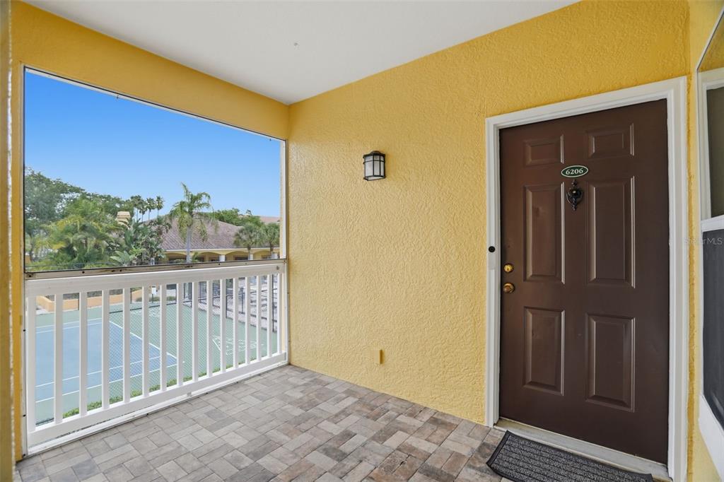 A living area features tile flooring, a brown leather sofa, and a wooden desk — 10764 70TH AVENUE UNIT 6206, SEMINOLE, FL