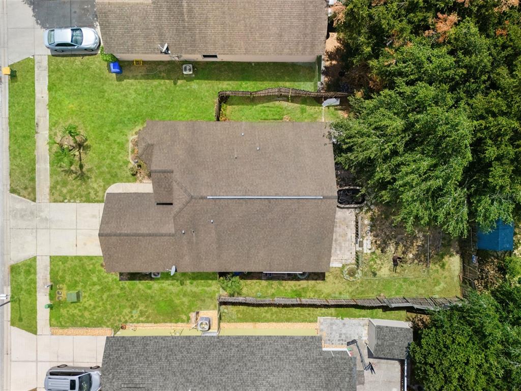 An aerial view shows a residential house with a brown roof, lawn, and driveway — 2318 BARONS COURT, TAVARES, FL