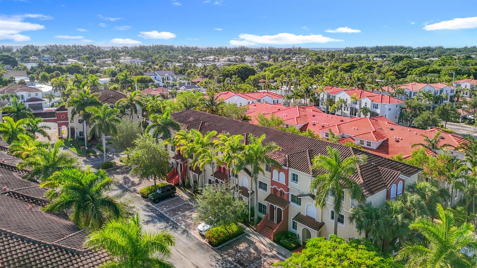 An aerial view shows a multi-story residential complex with red tile roofs and palm trees — 312 Bayfront Drive, Boynton Beach FL 33435, BOYNTON BEACH, FL