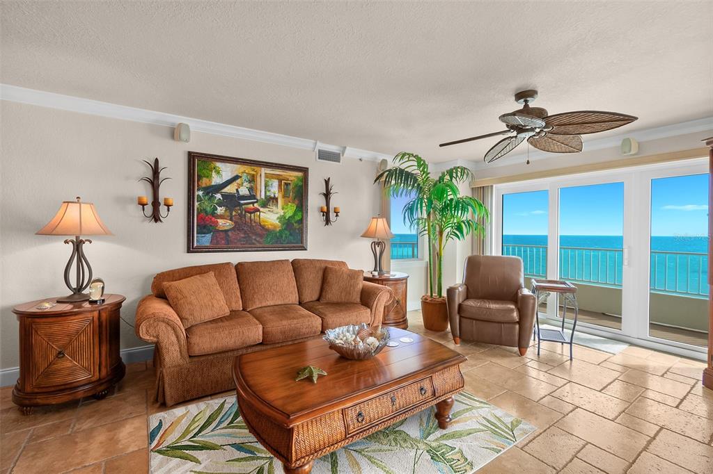A living room with a sofa, coffee table, and ocean views through sliding glass doors — 2937 S ATLANTIC AVENUE UNIT 1907, DAYTONA BEACH SHORES, FL