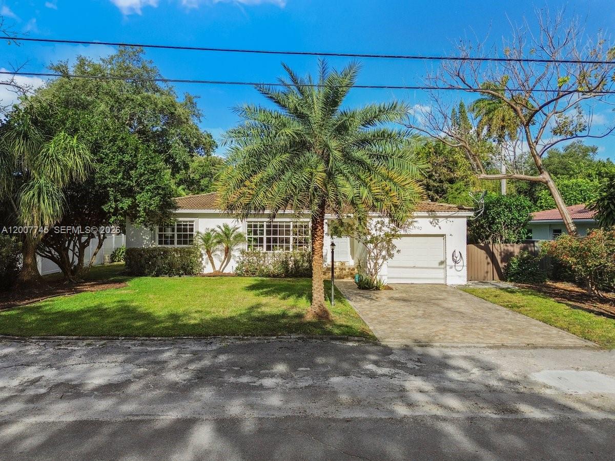 A single-story white house with a palm tree, a paved driveway, and a garage — 11790 NE 8th Ave, Biscayne Park FL 33161, BISCAYNE PARK, FL