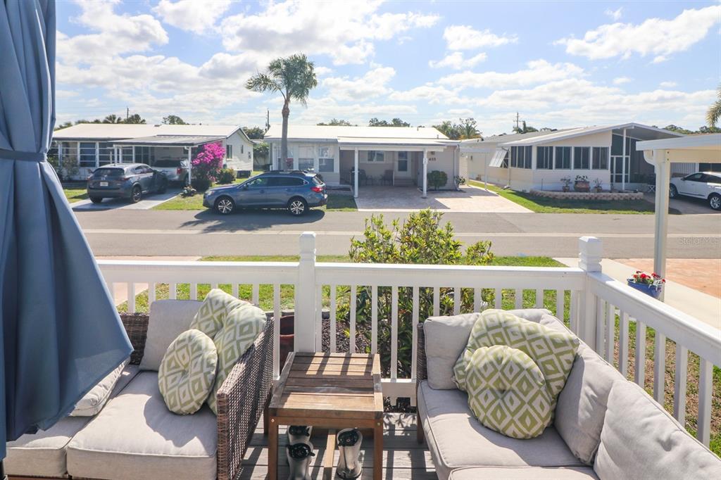 A view from a deck featuring outdoor seating overlooking a street with neighboring houses — 2100 KINGS HIGHWAY UNIT 662, PORT CHARLOTTE, FL