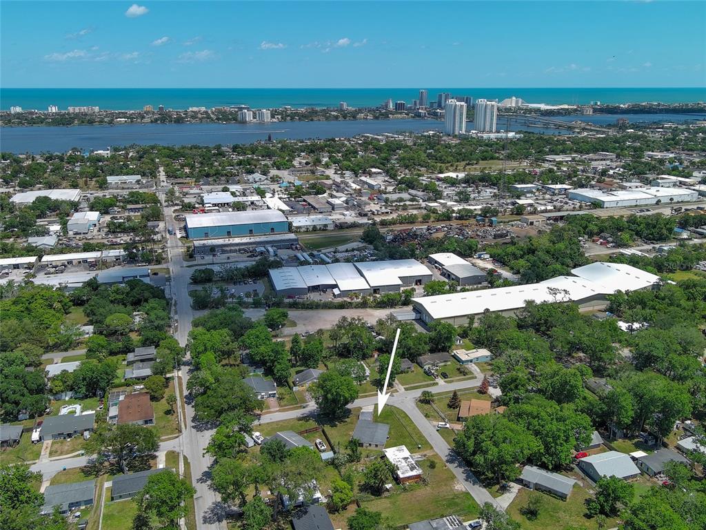 An aerial view shows a residential property marked by an arrow amidst a suburban neighborhood — 536 DOROTHY AVENUE, DAYTONA BEACH, FL