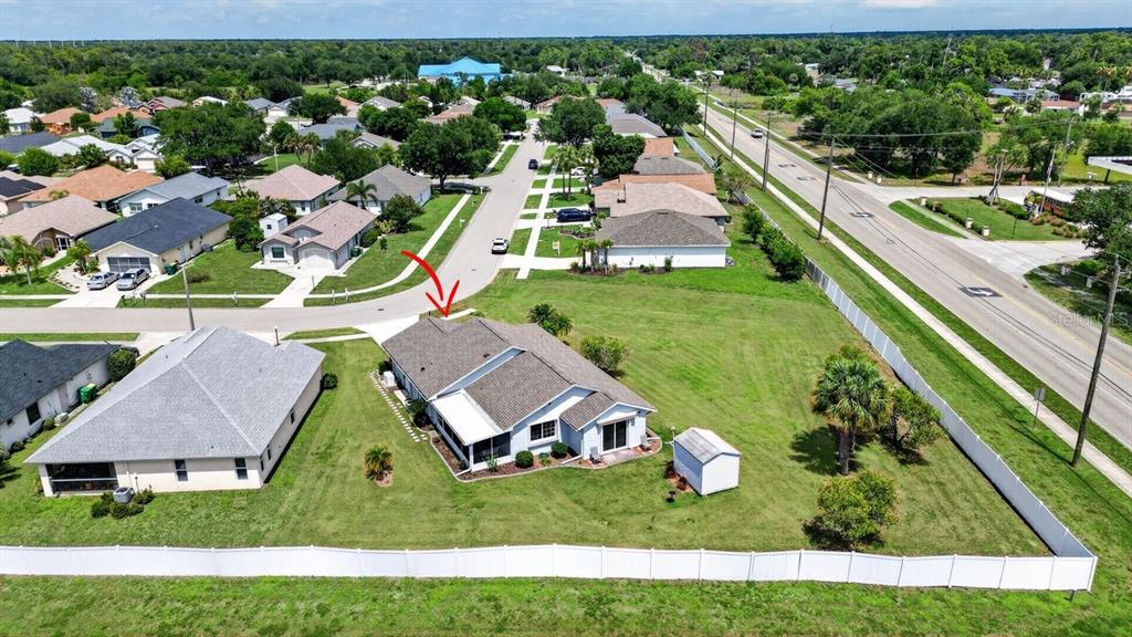 An aerial view shows a single-story house with a fenced yard and a detached shed — 548 ROSE APPLE CIRCLE, PORT CHARLOTTE, FL