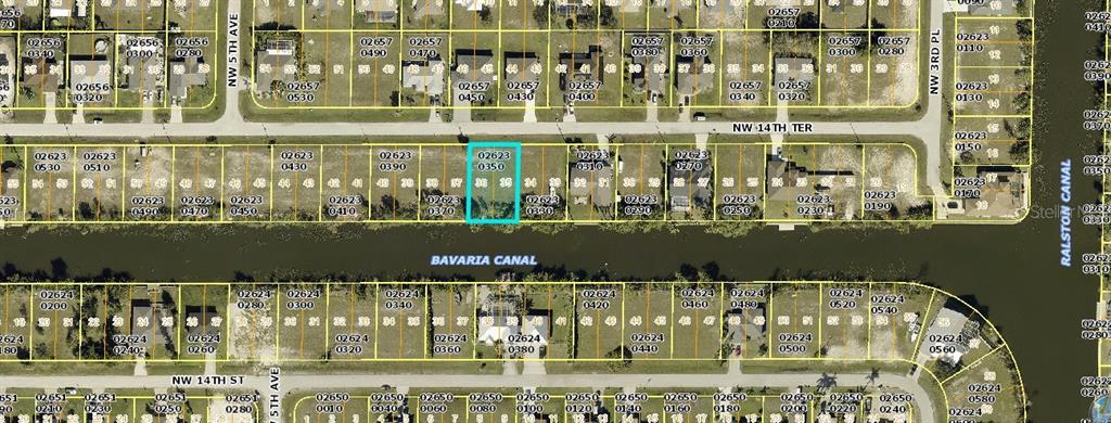 This is a satellite map view showing a highlighted vacant residential lot along a canal — 418 NW 14TH TERRACE, CAPE CORAL, FL