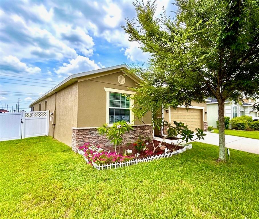 An aerial view shows a residential house with a red arrow pointing to its roof — 619 WABASH BREEZE CIRCLE, RUSKIN, FL