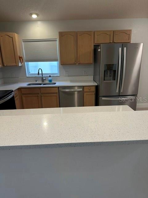 A kitchen features light wood cabinets, stainless steel appliances, and white quartz countertops — 1525 CHALLENGER AVENUE, DAVENPORT, FL