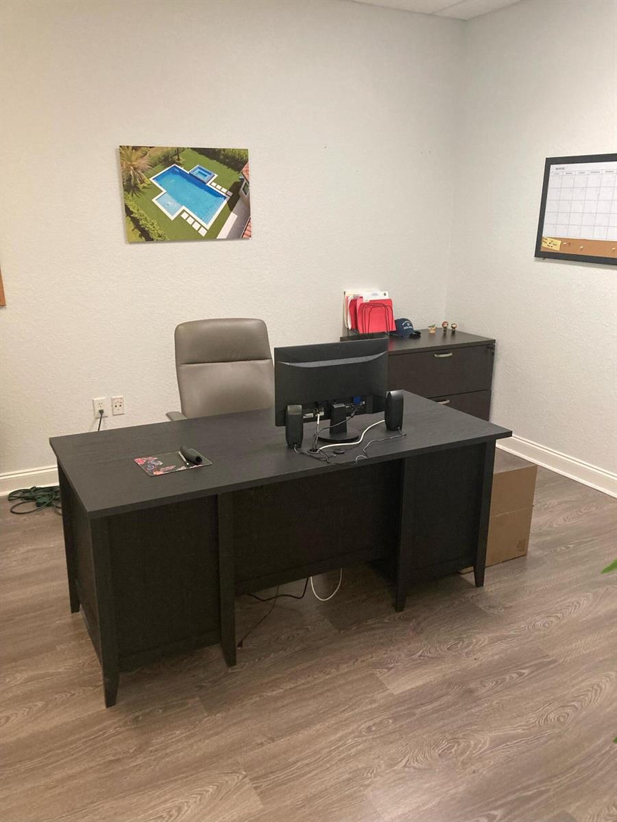 A home office features a dark wood desk, a gray chair, and a pool photograph — 1921 Banks Road, Margate FL 33063, MARGATE, FL