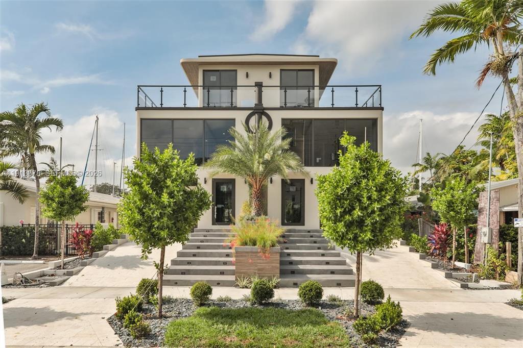 A modern three-story house features a symmetrical facade with large windows and a central staircase — 321 Hendricks Isle, Fort Lauderdale FL 33301, FORT LAUDERDALE, FL
