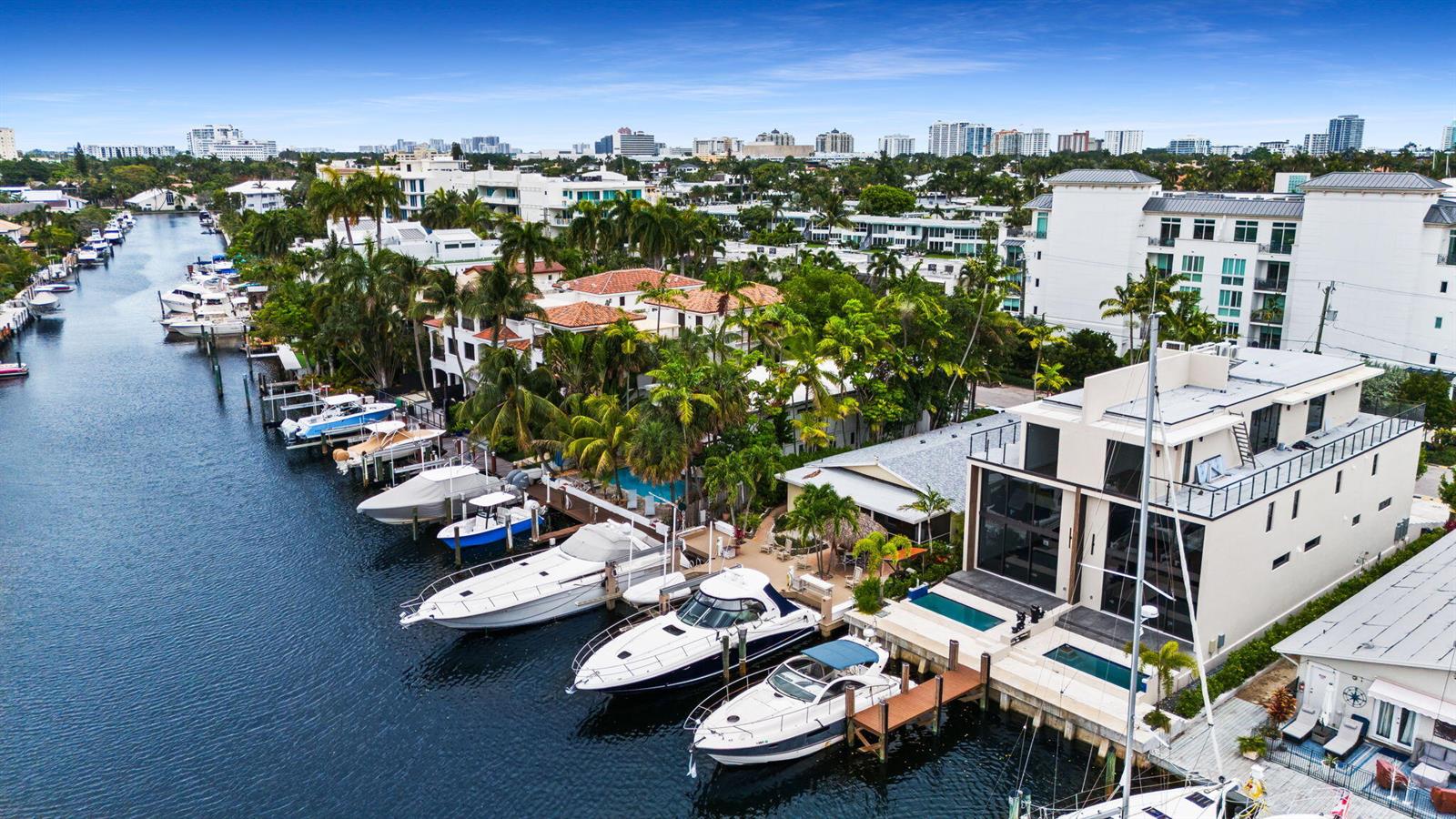 An aerial view of a canal lined with luxury yachts and waterfront homes with pools — 321 Hendricks Isle, Fort Lauderdale FL 33301, FORT LAUDERDALE, FL