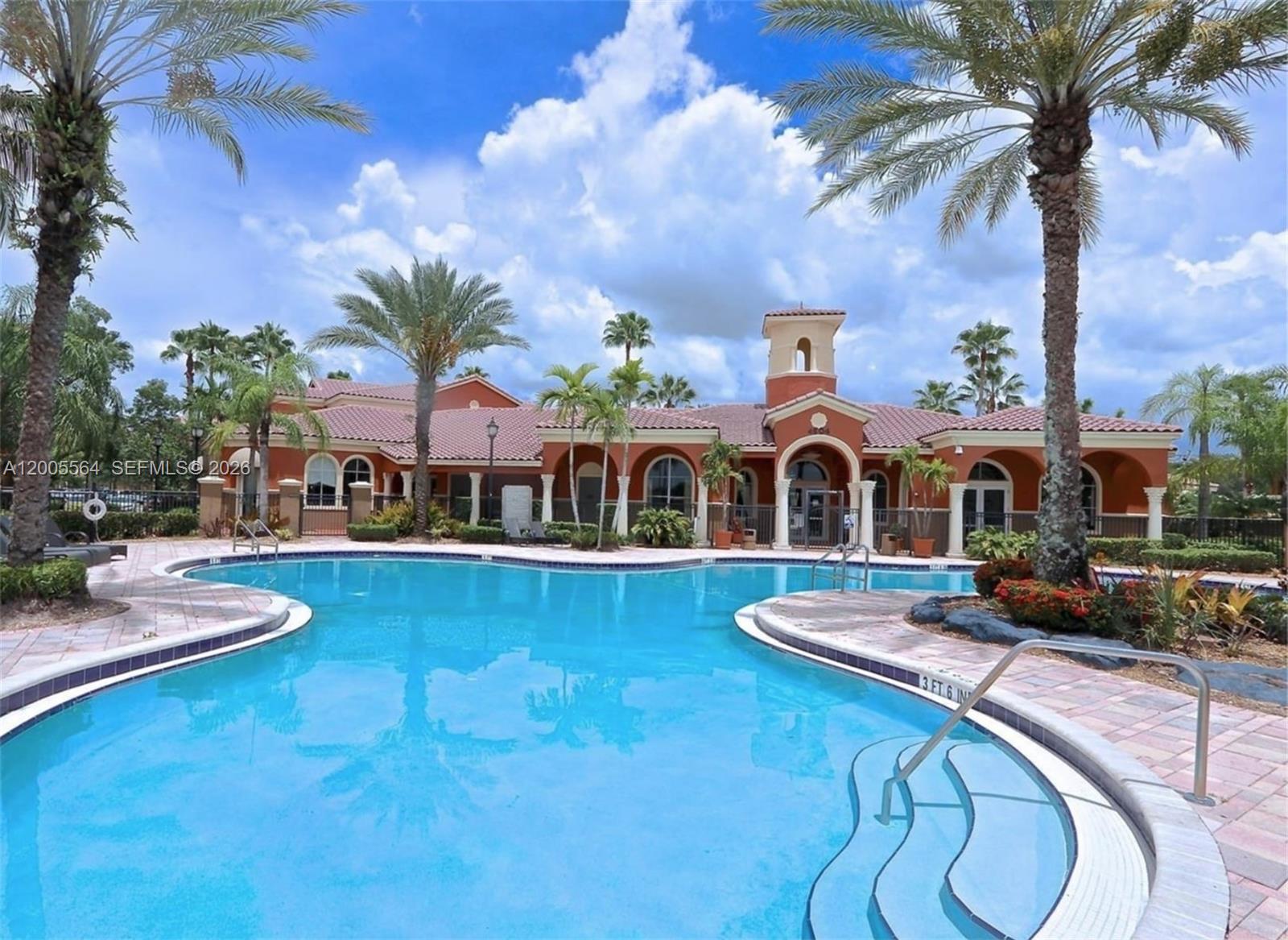 A paved road leads past a guardhouse and tall palm trees in a residential community — 4508 SW 160th Ave # 736, Miramar FL 33027, MIRAMAR, FL