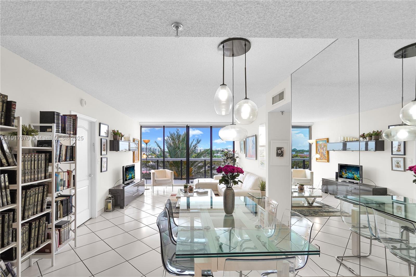 A living and dining area features white tile floors, a glass table, and floor-to-ceiling windows — 9455 Collins Ave # 603, Surfside FL 33154, SURFSIDE, FL