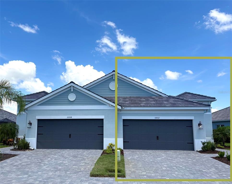A gray garage door with decorative hardware is centered on the exterior of a house — 10012 LAKE WALES CIRCLE, SARASOTA, FL