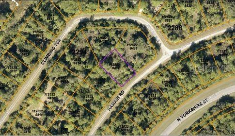 This is an aerial map showing a vacant lot outlined in purple near several roads — KAMAIN ROAD, NORTH PORT, FL
