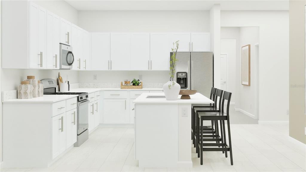 This kitchen features white cabinets, stainless steel appliances, a center island, and light-colored flooring — 18237 PLEASANTVIEW BOULEVARD, LAND O LAKES, FL
