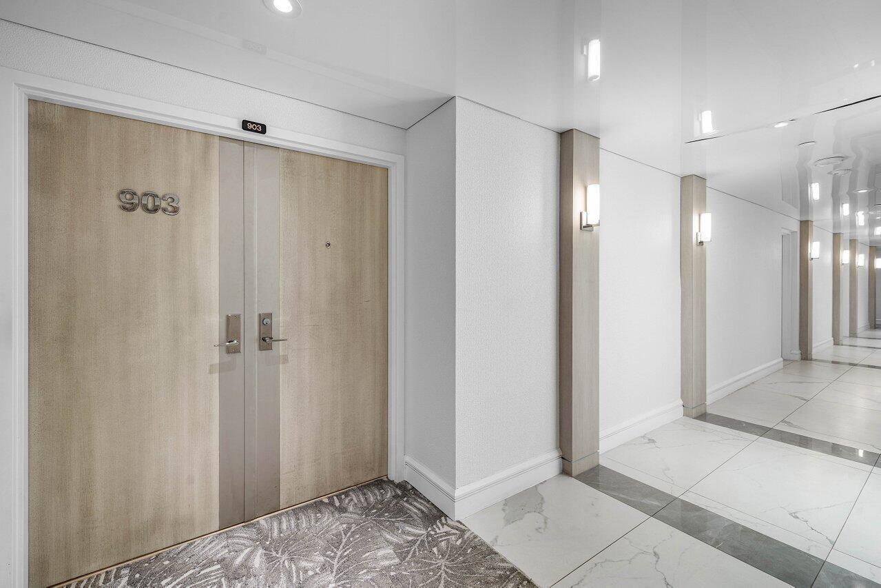 A double door with the number 903 leads to a hallway with white tile flooring — 3211 S Ocean Boulevard # 903, Highland Beach FL 33487, HIGHLAND BEACH, FL