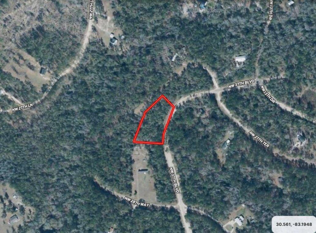 An aerial map view shows a vacant, wooded lot outlined in red — Lot 7 NW 27th Terrace, FL 32053, FL