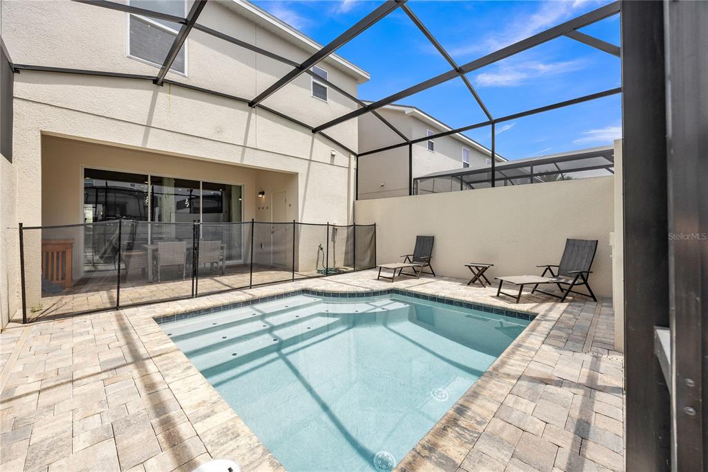 A screened-in patio features a small rectangular swimming pool and a paved deck area — 2362 ZABALLINA PLACE, KISSIMMEE, FL