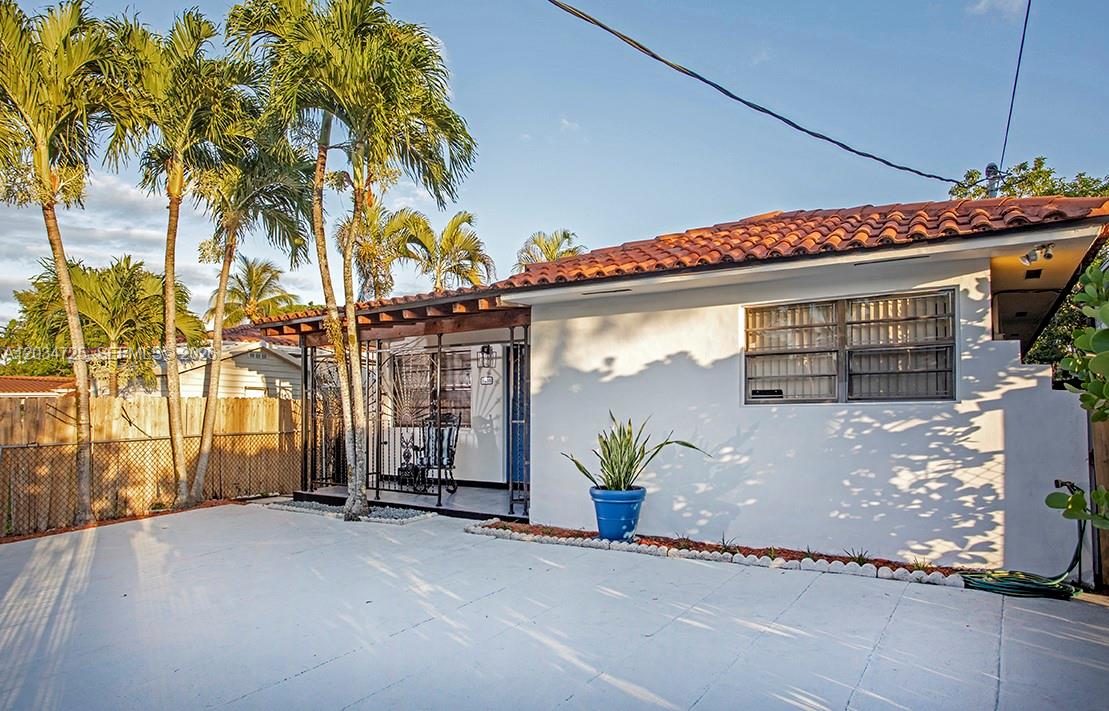 A white house with a tiled roof, palm trees, and a paved front patio area — 3610 SW 14th St, Miami FL 33145, MIAMI, FL