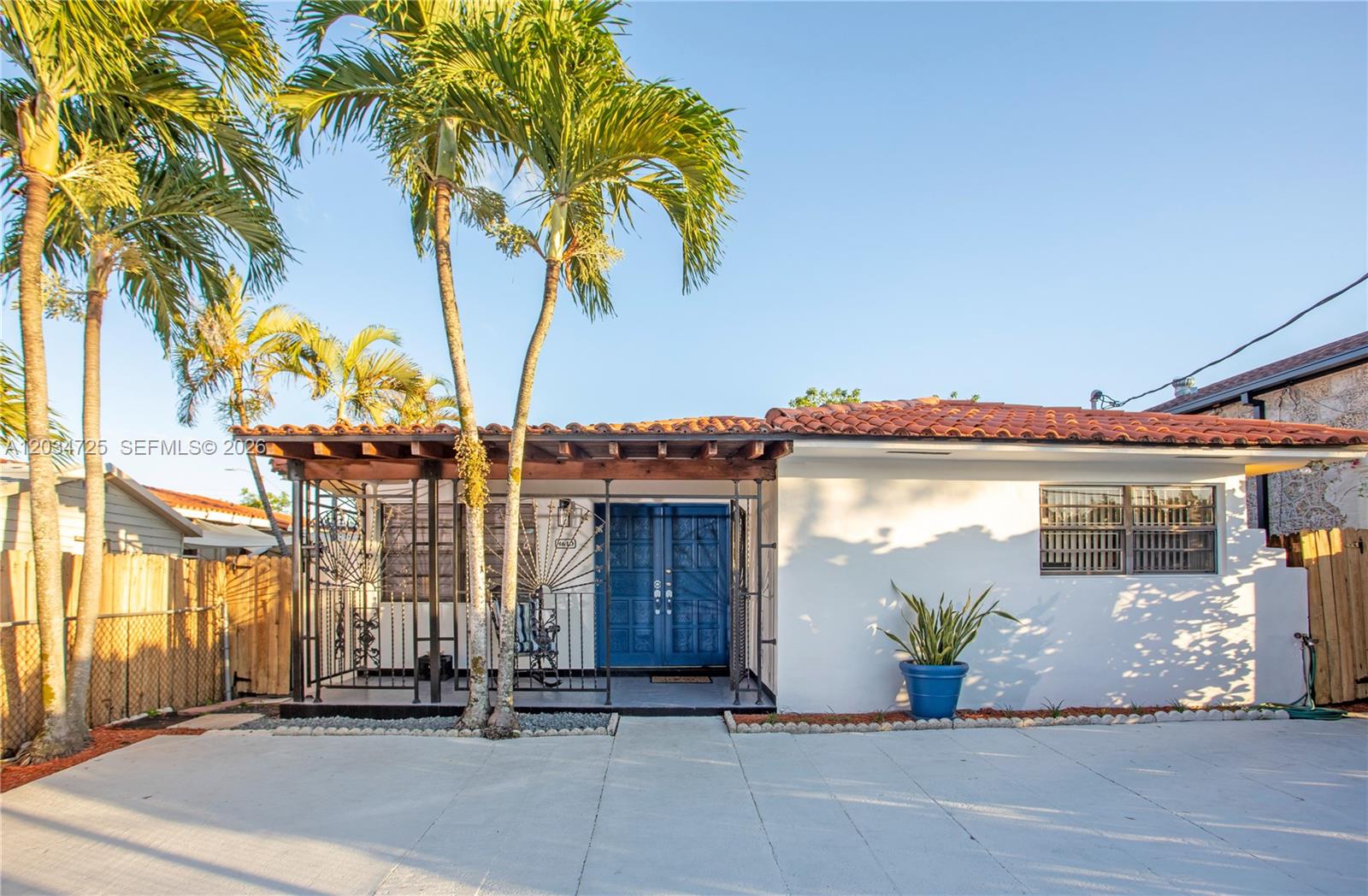A single-story house with a white exterior, blue double doors, and a tiled roof — 3610 SW 14th St, Miami FL 33145, MIAMI, FL