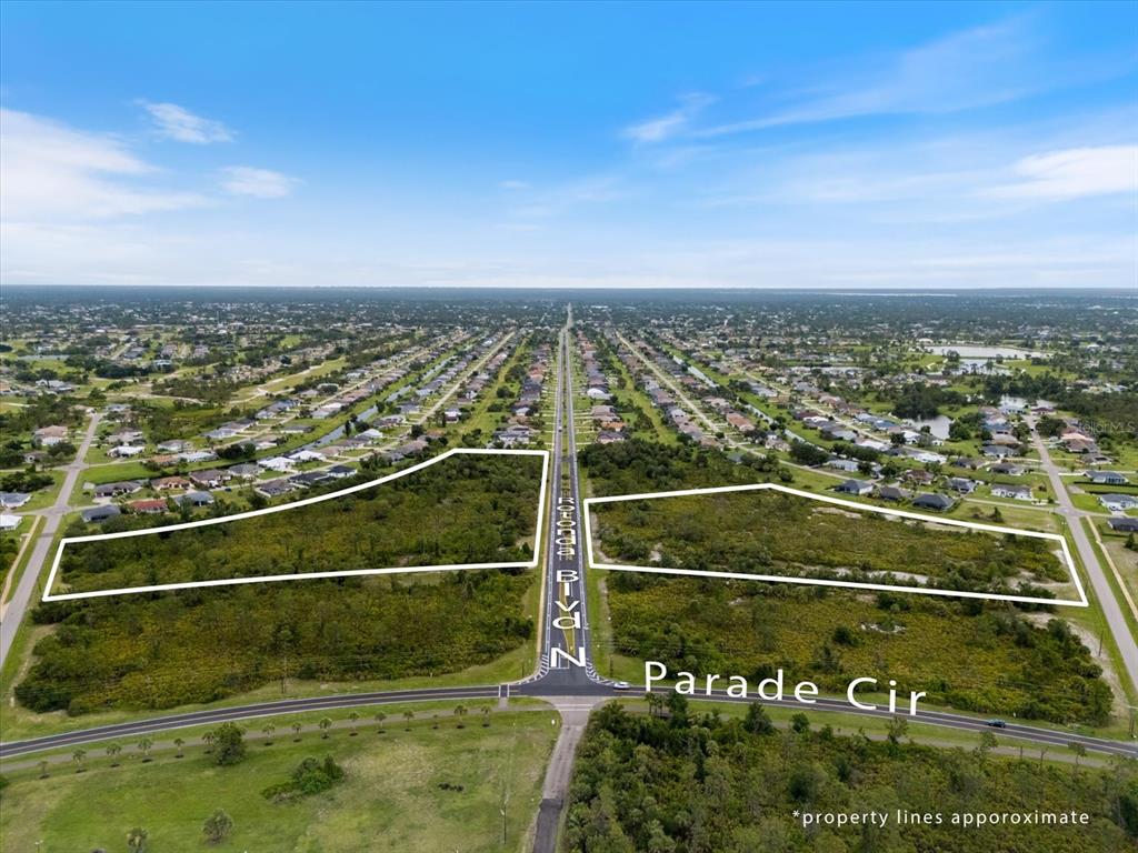 An aerial view shows two vacant, undeveloped lots separated by a road — 151 ROTONDA BOULEVARD N, ROTONDA WEST, FL
