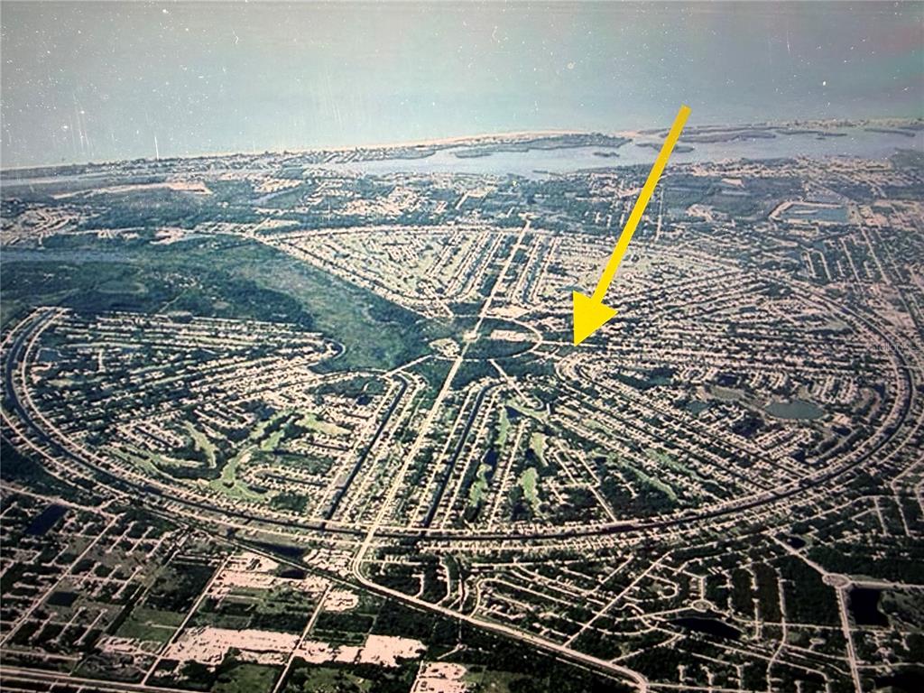 Aerial view of a circular residential neighborhood with a golf course and surrounding water — 151 ROTONDA BOULEVARD N, ROTONDA WEST, FL
