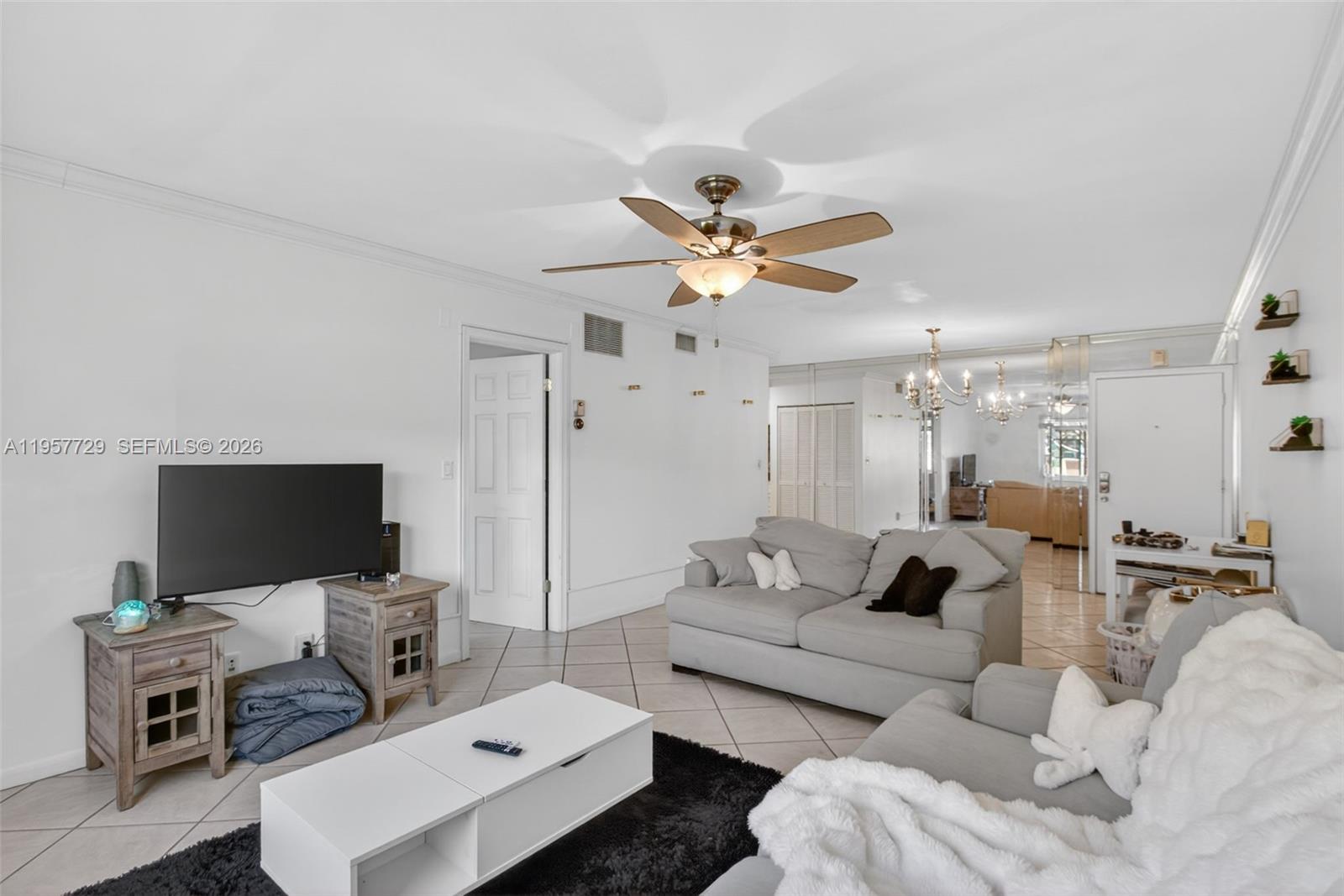 A living room features light tile floors, a ceiling fan, and two grey sofas — 9 NE 19th Ct # 104C, Wilton Manors FL 33305, WILTON MANORS, FL