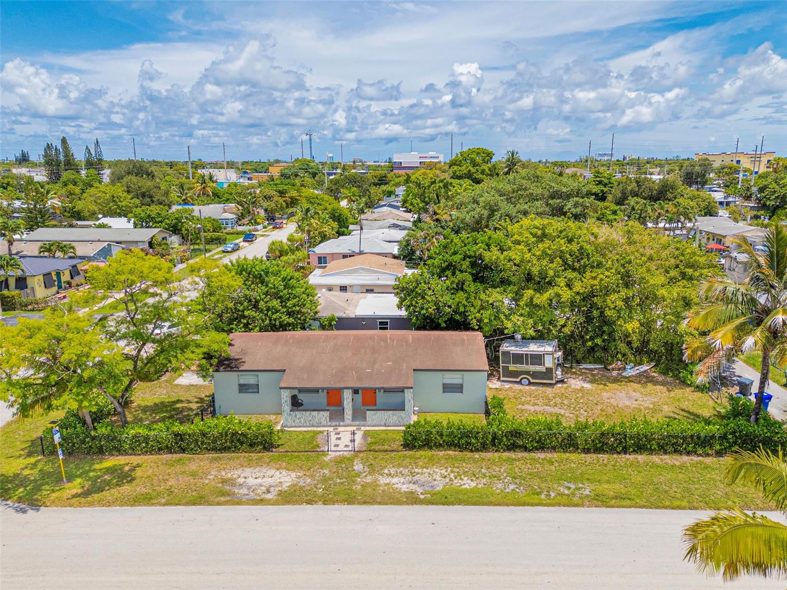 An aerial view shows a single-story duplex with a brown roof and orange doors — 1923 N 23rd Avenue, Hollywood FL 33020, HOLLYWOOD, FL