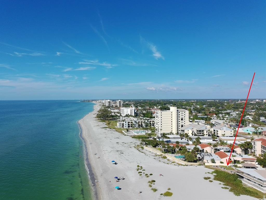 An aerial view of a sandy beach coastline with nearby residential buildings and hotels — 702 HIBISCUS DRIVE, VENICE, FL