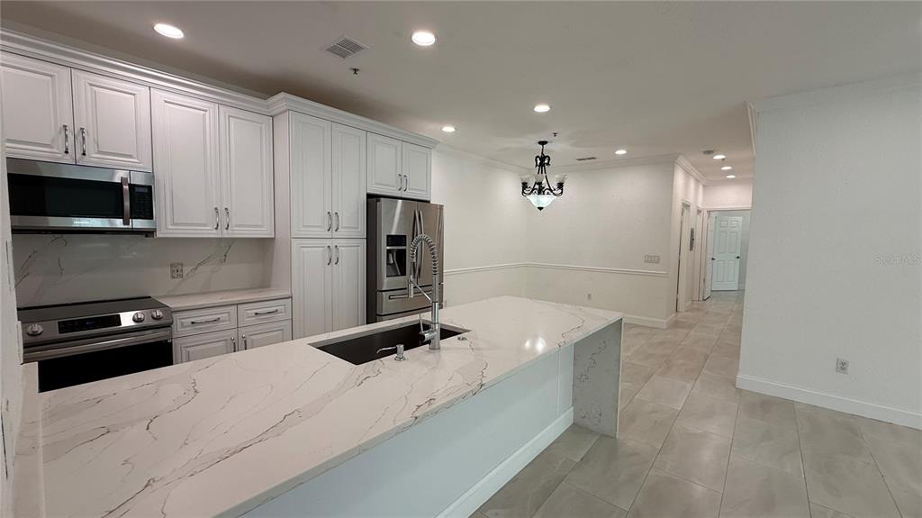 A brown front door with a lockbox is set into a textured gray wall — 16303 ENCLAVE VILLAGE DRIVE UNIT 103, TAMPA, FL