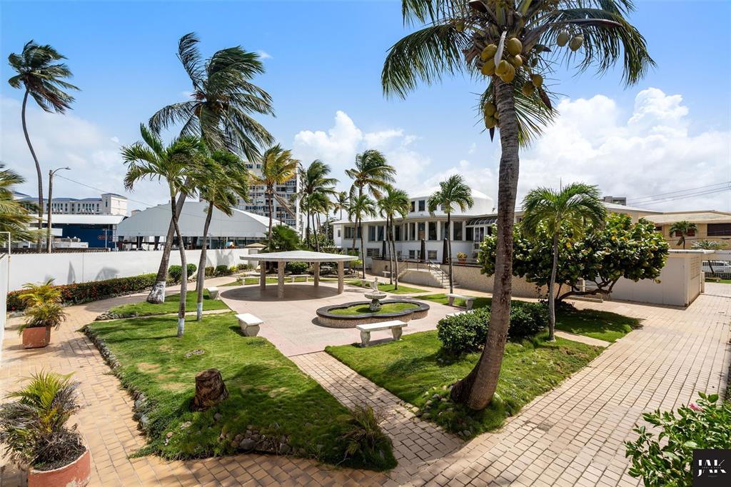 An outdoor courtyard features a central fountain, a gazebo, palm trees, and paved walkways — 20 AMAPOLA STREET, CAROLINA, PR