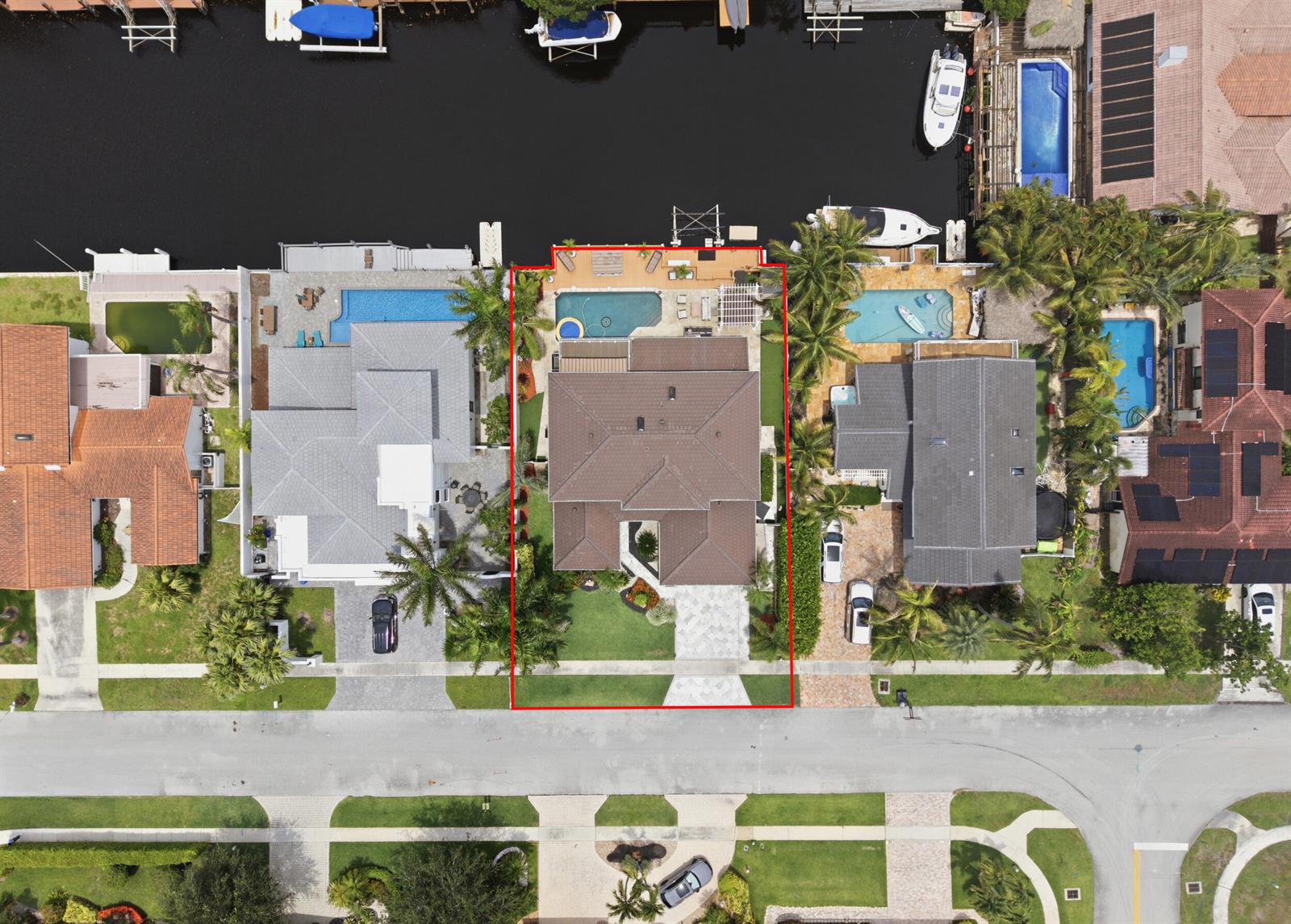 Aerial view of a residential property with a pool, deck, and boat dock on a canal — 1548 SW 5th Avenue, Boca Raton FL 33432, BOCA RATON, FL