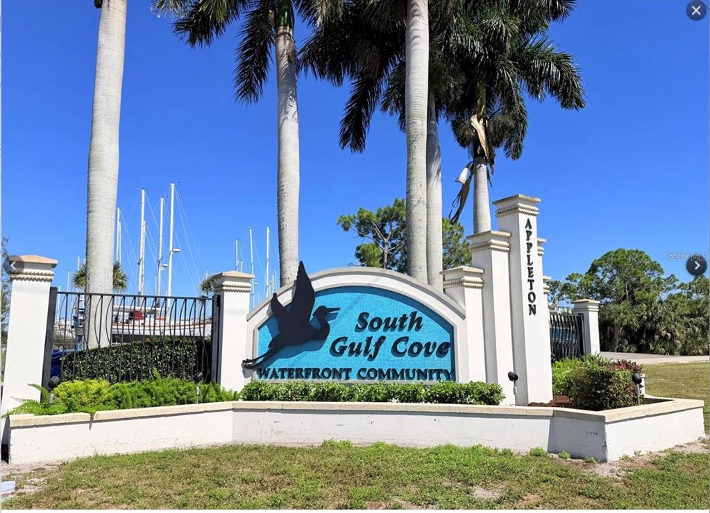 A sign for South Gulf Cove waterfront community stands in front of palm trees and boats — 10380 PORT EVERGLADES STREET, PORT CHARLOTTE, FL