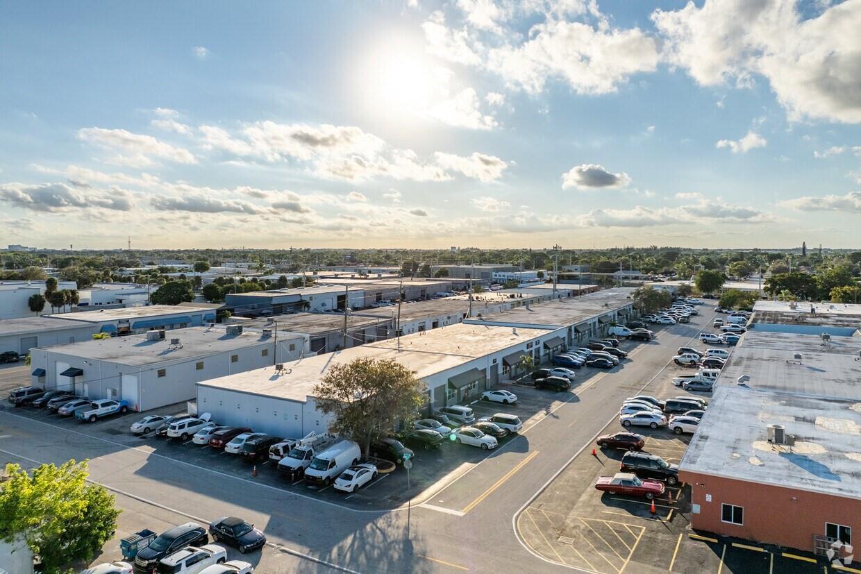 An aerial view shows several industrial warehouse buildings with parking lots and surrounding trees — 400 NE 27th Street, Pompano Beach FL 33064, POMPANO BEACH, FL