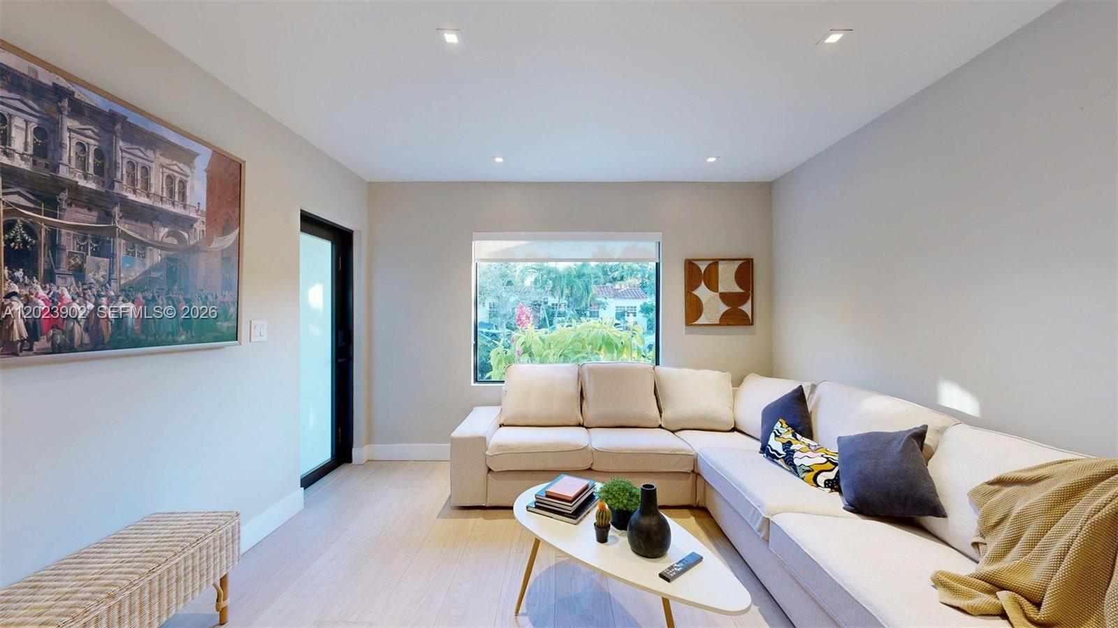 A living room features a beige sectional sofa, a coffee table, and a large wall painting — 1277 SW 19th St, Miami FL 33145, MIAMI, FL