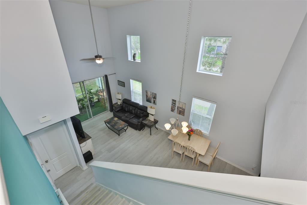 An elevated view of a living and dining area with high ceilings and light flooring — 3019 OLD FULTON PLACE, BRANDON, FL