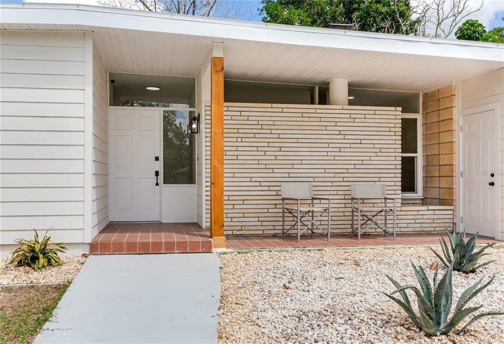 An entryway features a white front door, light wood flooring, and a hallway with doors — 2753 VALENCIA DRIVE, SARASOTA, FL