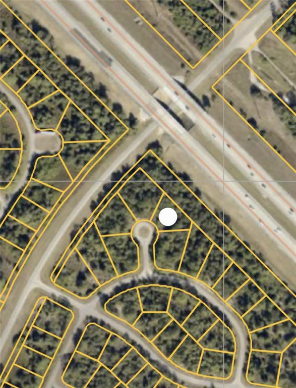 This is an aerial map showing a vacant lot marked with a white circle — DADE COURT, NORTH PORT, FL