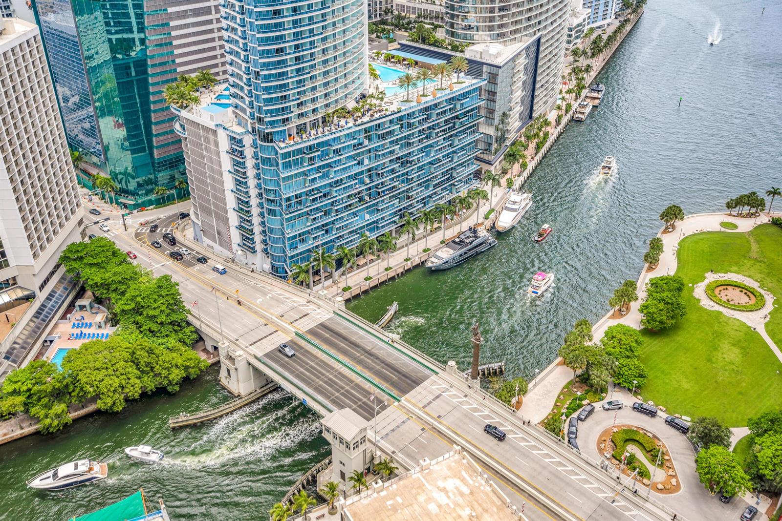 An aerial view shows a drawbridge over a river flanked by high-rise buildings and parks — 77 SE 5th Street # 2014, Miami FL 33131, MIAMI, FL
