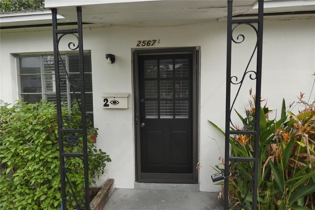 The exterior entrance features a dark door, a white mailbox, and decorative black metal pillars — 2567 15TH AVENUE N UNIT 2, ST PETERSBURG, FL