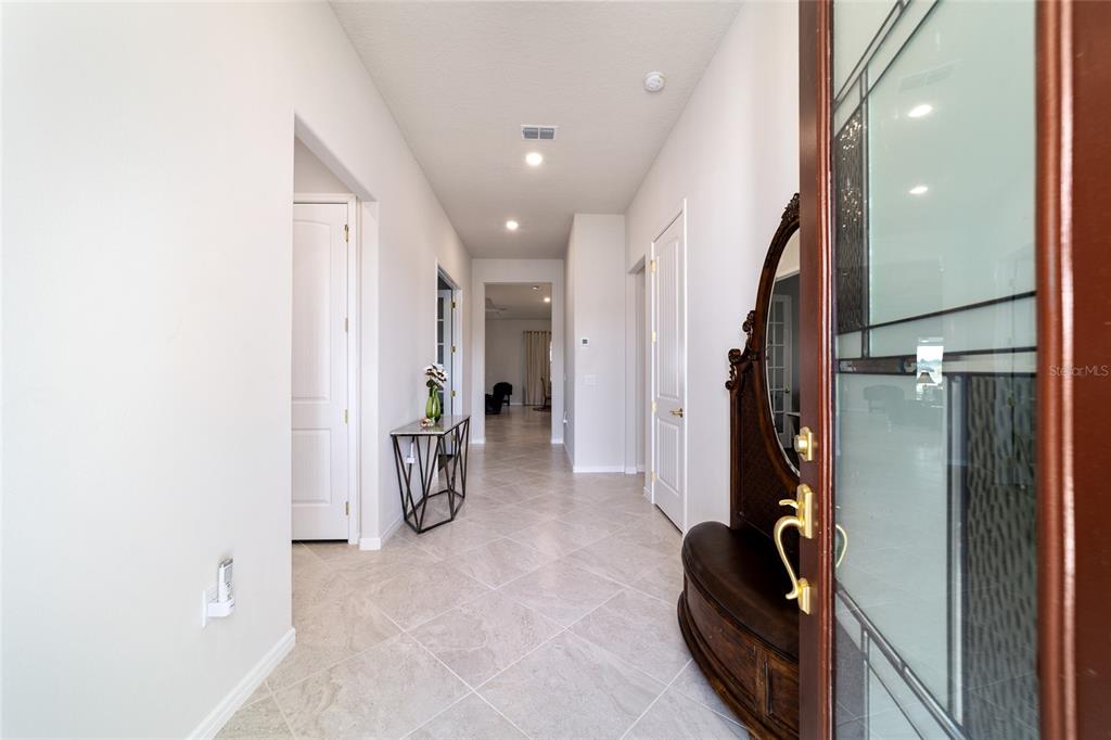 A tiled entryway leads down a hallway past a console table and interior doors — 8828 SW 61ST LOOP, OCALA, FL