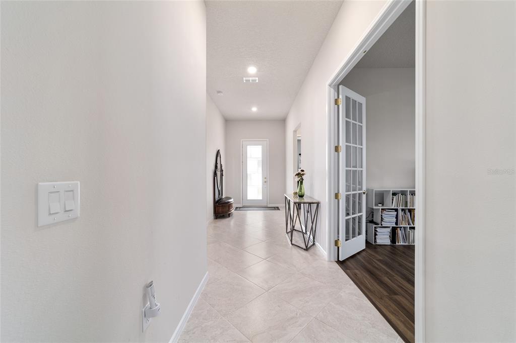 A tiled hallway leads to a front door, with a French-door office on the right — 8828 SW 61ST LOOP, OCALA, FL