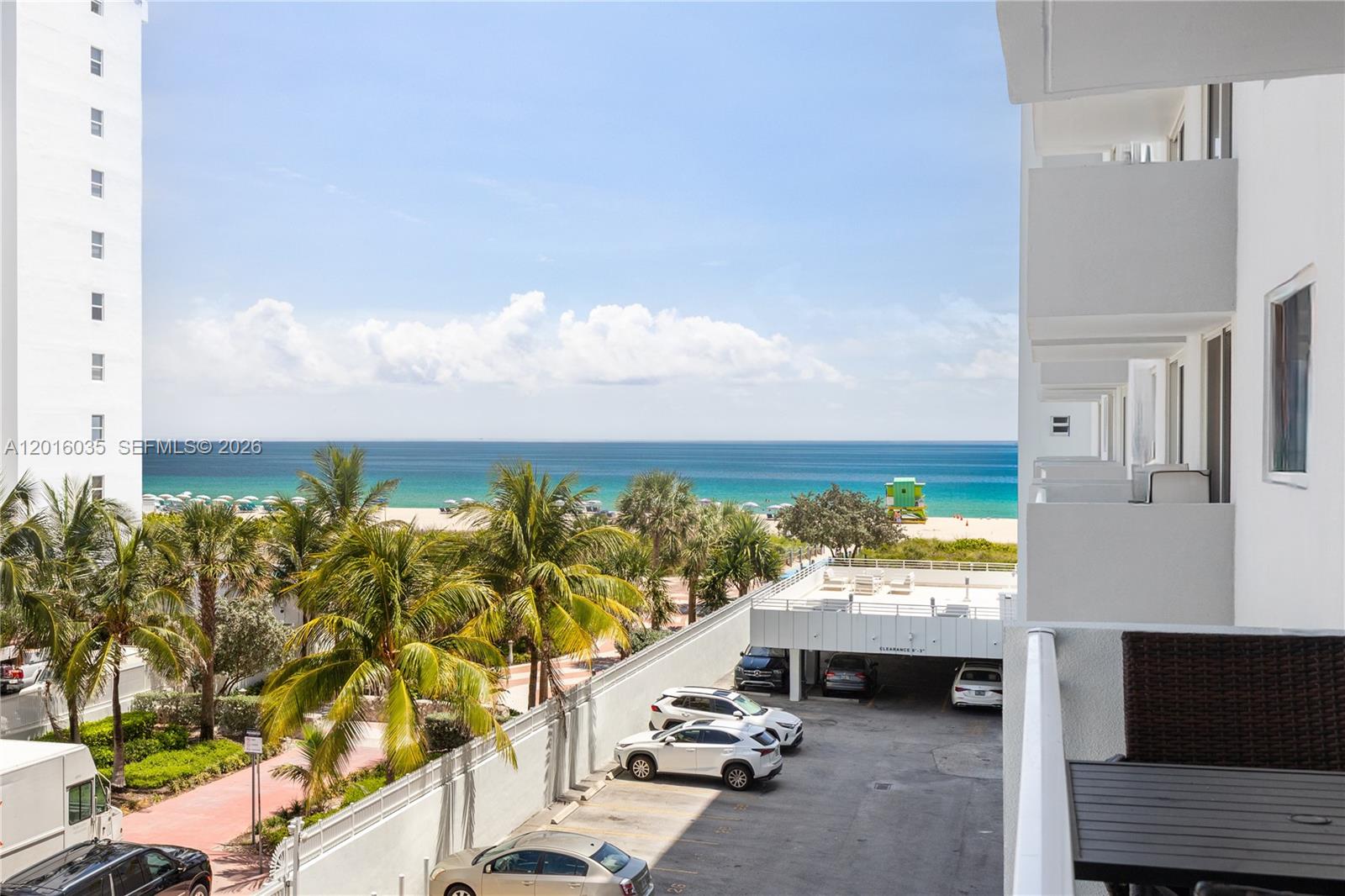 An elevated view shows a parking lot, palm trees, and a beach with the ocean — 345 Ocean Dr # 424, Miami Beach FL 33139, MIAMI BEACH, FL
