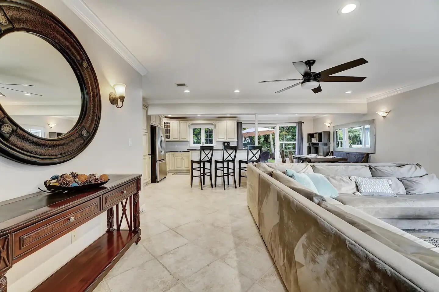 A living room with a large sectional sofa, a console table, and an open kitchen — 5574 Lake Osborne Drive, Lake Worth FL 33461, LAKE WORTH, FL
