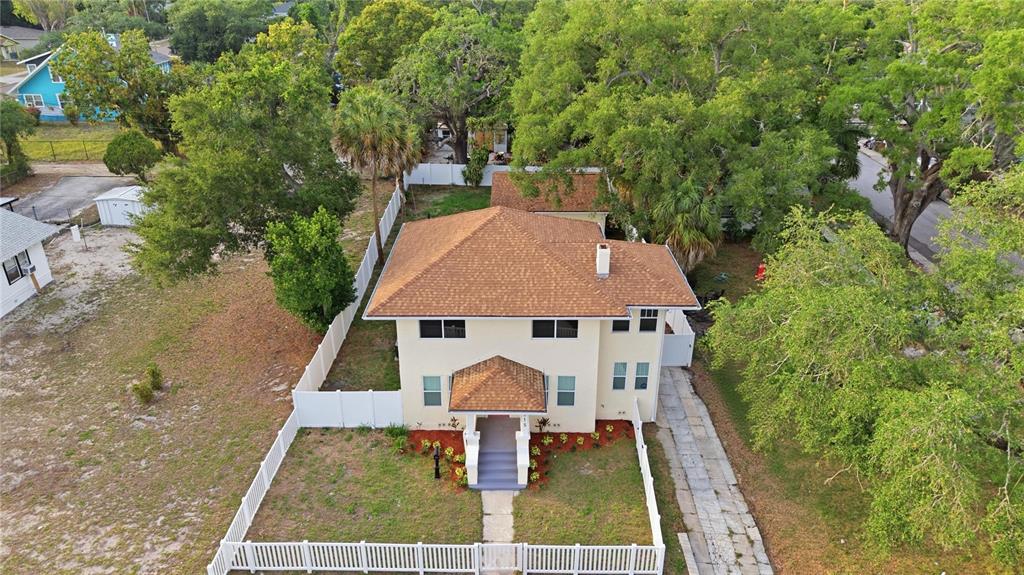An aerial view shows a two-story house with a tan exterior and brown roof — 1315 22ND AVENUE S, ST PETERSBURG, FL